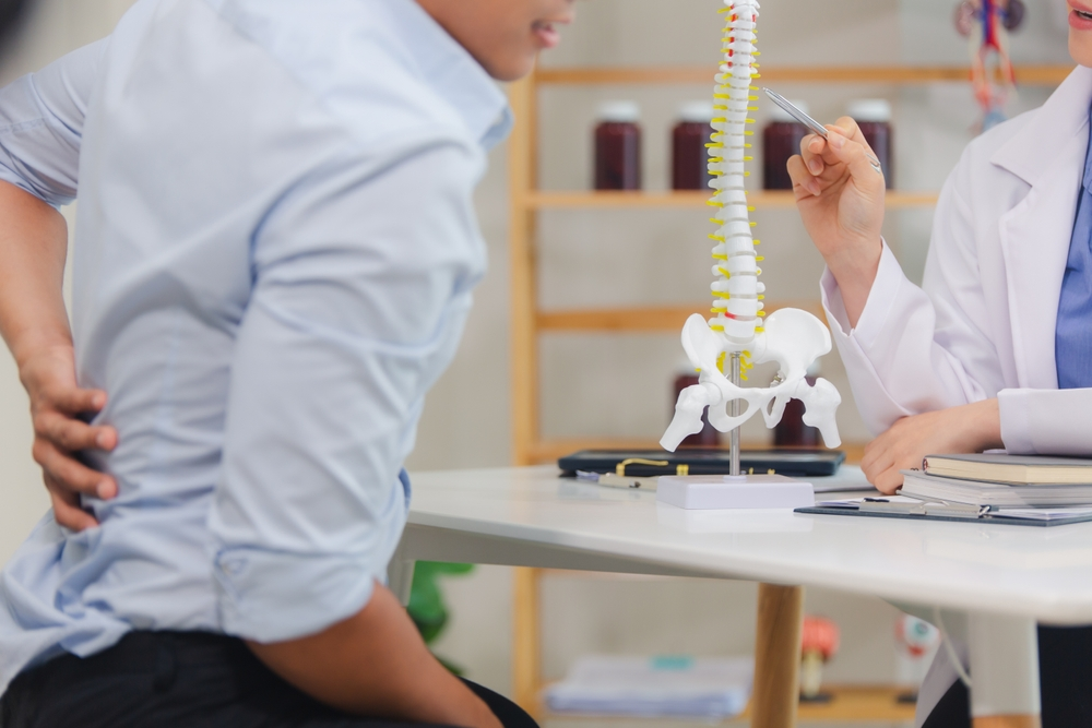 Doctor explains back pain to man - Lawsuit Legal News