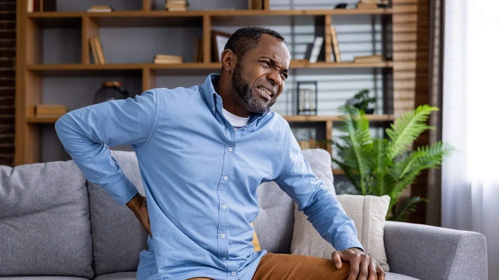 Middle-aged man experiencing back pain - Lawsuit Legal News