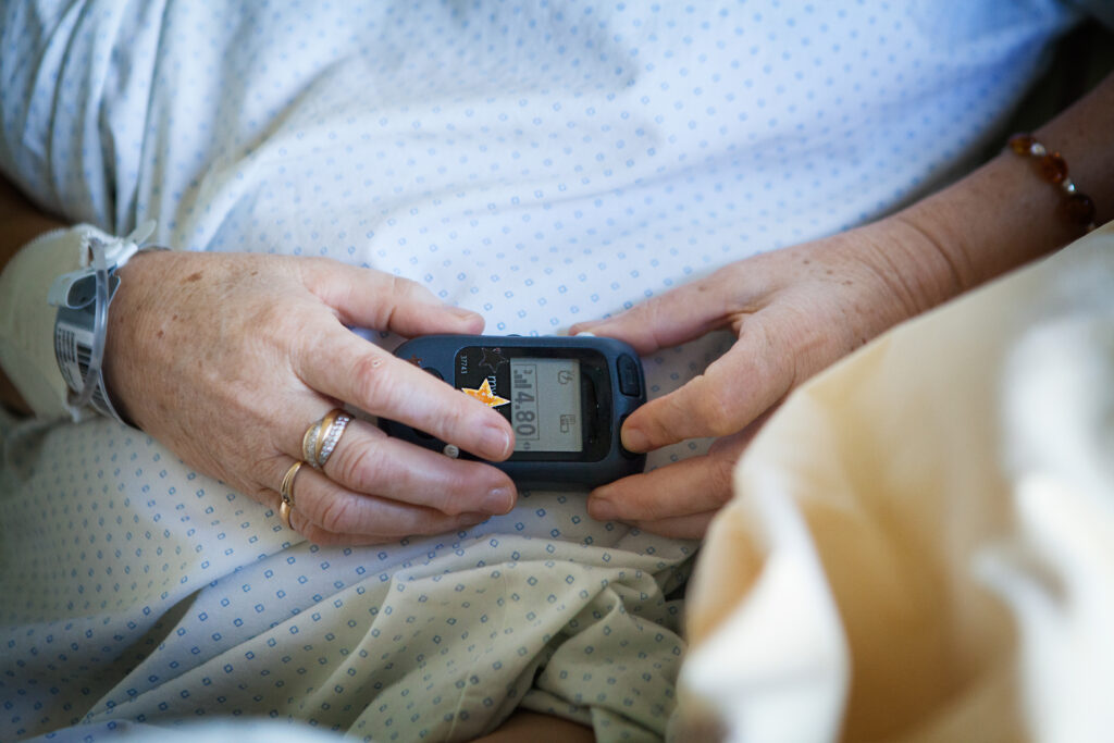 patient adjusting her spinal cord stimulator - Spinal Cord Stimulator Implant Procedure - Lawsuit Legal News